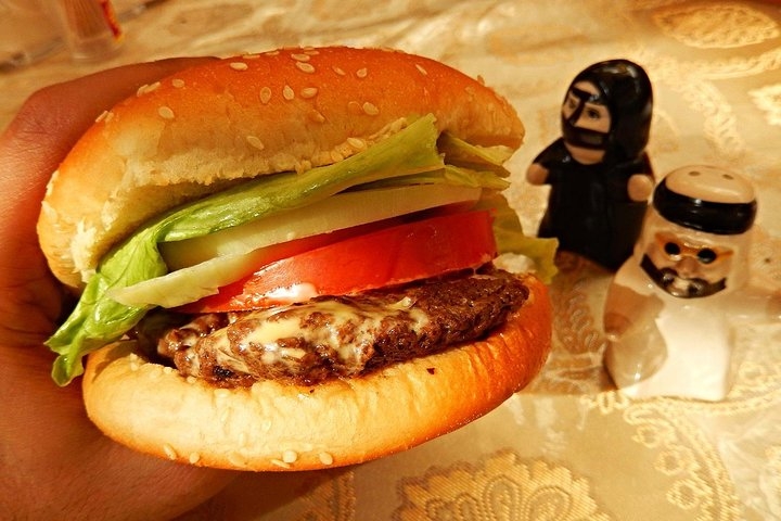 Experience Dubai's unique culinary culture with a camel burger surrounded by charming traditional souvenirs. Dive into a blend of flavors and rich heritage on this private tour adventure.